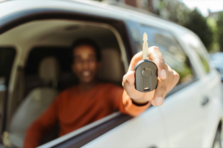 Auto locksmith making a replacement car key in Denver